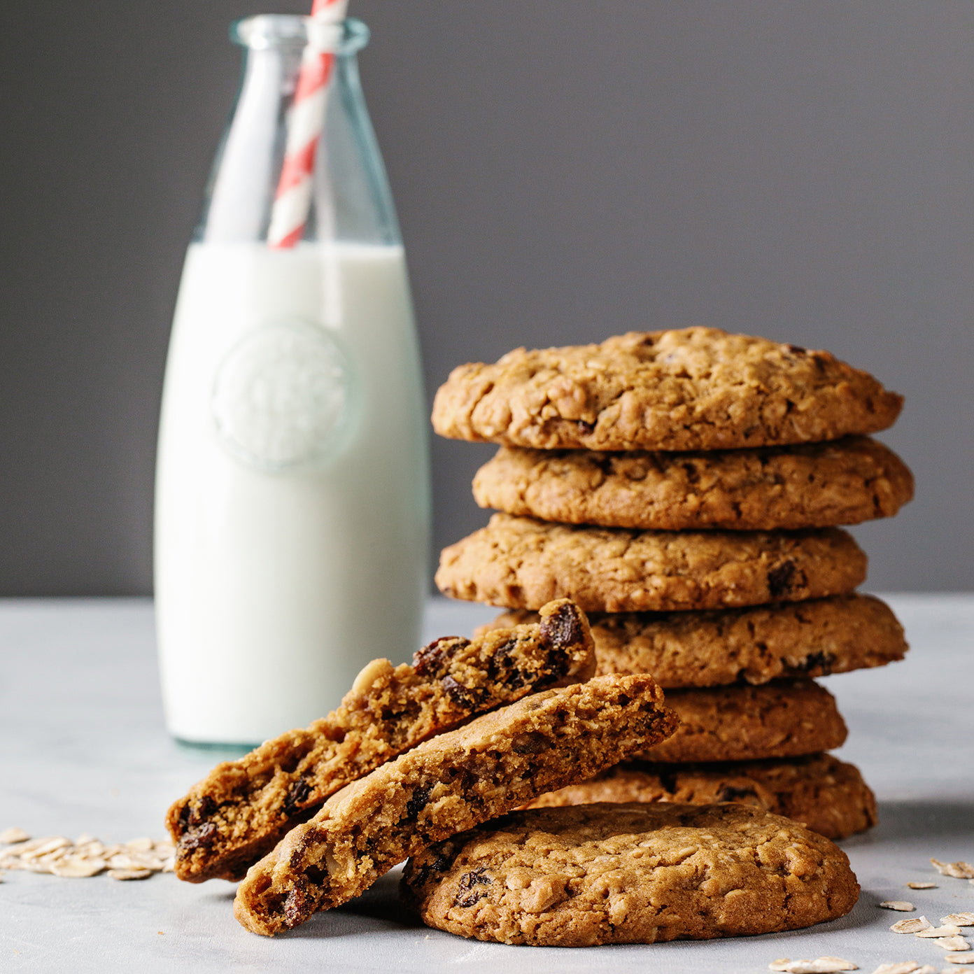 Oatmeal cookies stacked with milk.